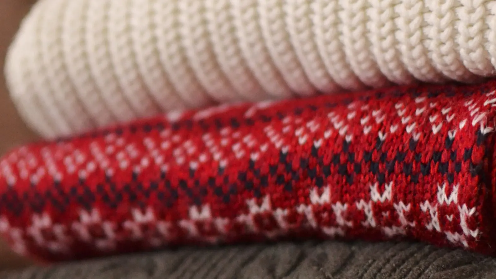 Folded wool sweater, representing careful washing of wool knitwear.