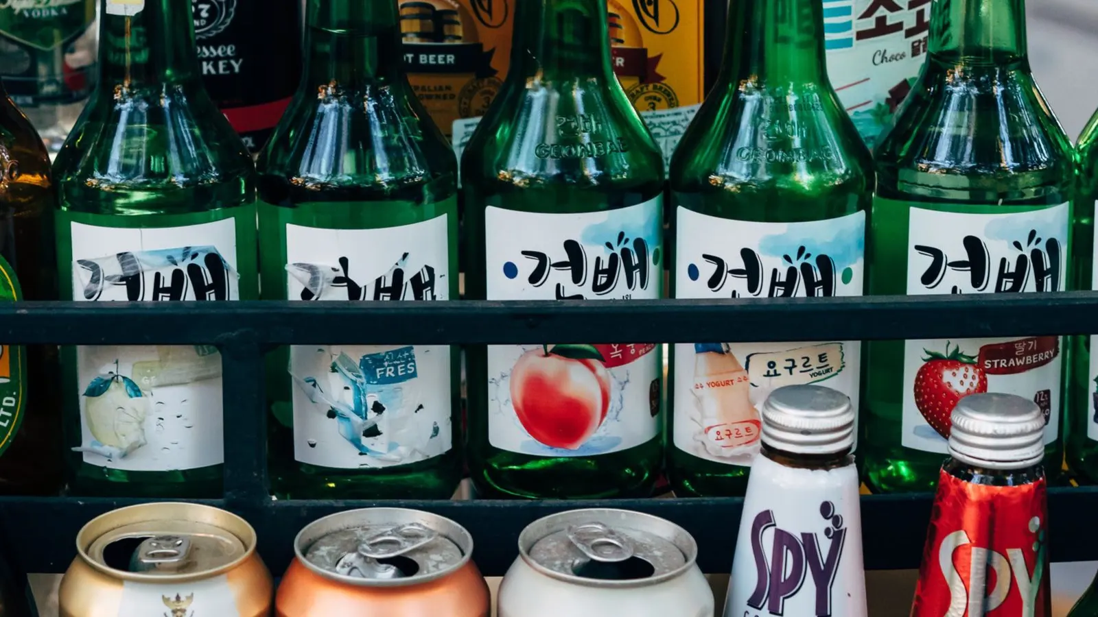 Bottles in a labeling station, representing manual and semi-automatic round bottle labelers.