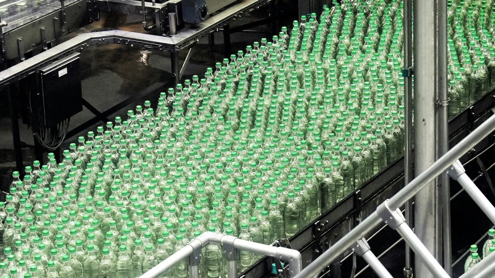 A bottling line with filling and packaging equipment, representing shrink-band application automation.