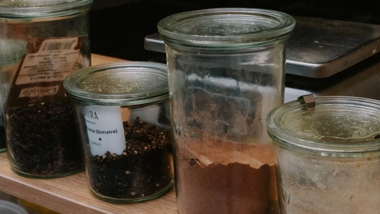 Seasoning bottles and jars, representing narrow-mouth spice bottle filling.
