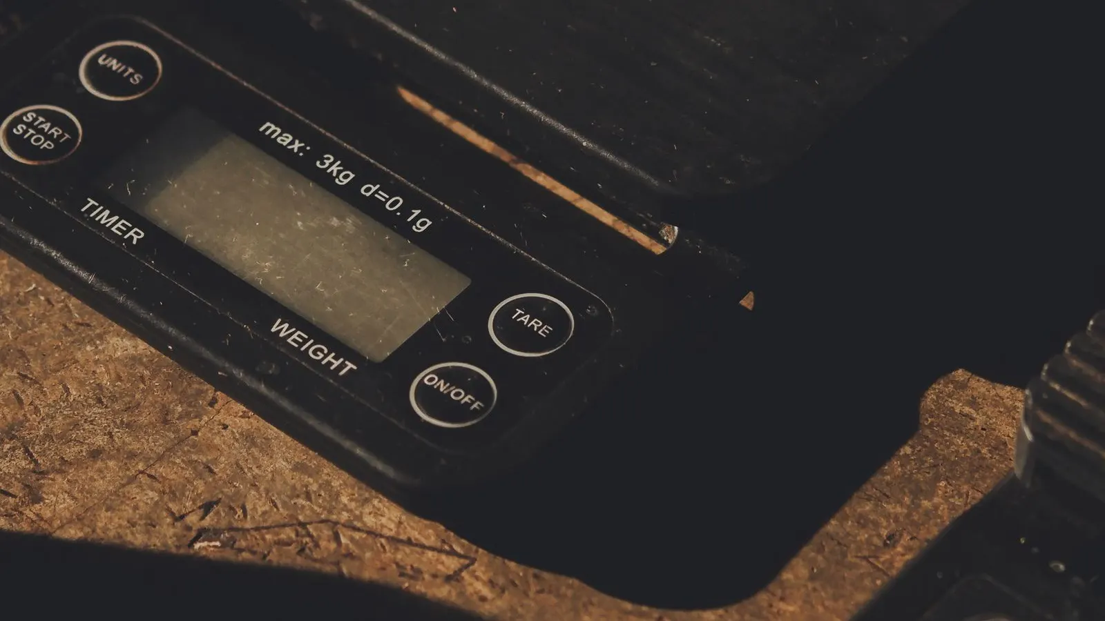Digital weighing scale, representing net-weight control for coffee bags.